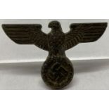 A German WWII style SA Kepi Eagle badge.
