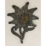 A WWII style German Gebirgsjager Edelweiss hat badge.