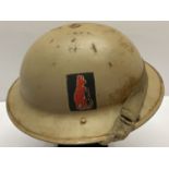 A WWII style British 8th Army helmet with liner.