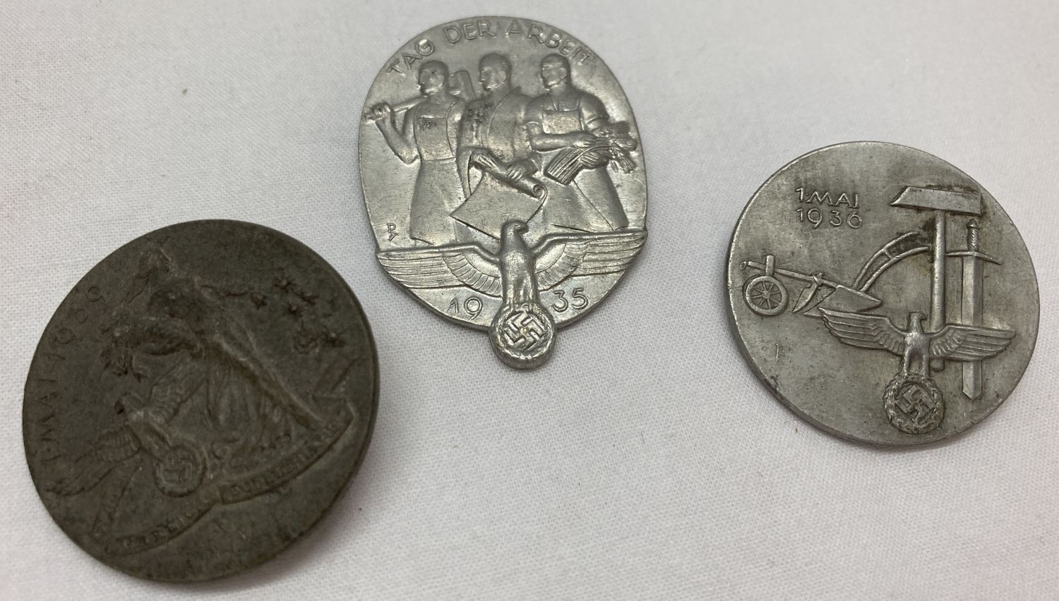 3 German WWII style tinny badges.