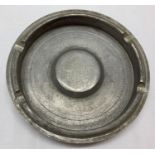A WWII style Battle Of Britain memento ashtray made from a Spitfire piston. In worn condition.