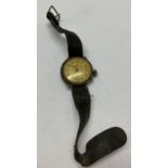 A WWI style Officers wrist watch with leather straps and engraving to reverse.