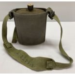 WWII style British enamel water bottle in webbing carrier.