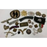 A collection of assorted Military medals and badges. To include cloth badges and cap badges.