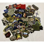 A quantity of assorted embroidered cloth badges and patches.