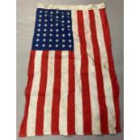 A WWII style US Navy Star & Stripes flag. Printed markings to one side.