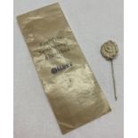 A WWII style German silver class drivers stick pin in wax paper packet.