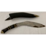 A vintage inlaid wooden handled Kukri with leather and brass scabbard.