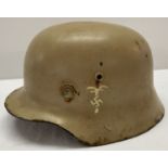 A WWII style German M35 Africa Corps helmet with replacement liner.