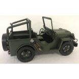 A new tin plate model of a military jeep, with moving wheels.