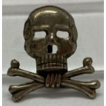 A WWII style German Brunswick skull, lug back badge.