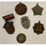 A collection of 6 Chinese medals and badges.