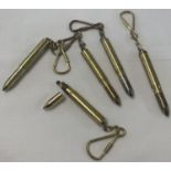 A collection of brass bullet shaped lighters, made into keyrings.