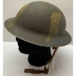 A WWI style American "Brodie" helmet with painted jigsaw pattern camouflage.