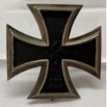 A WWII style German Iron Cross 1st class pin back badge.