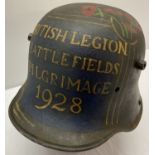 A WWI Imperial German M16 Stahlhelm helmet with hand painted detail.