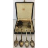 A cased set of 12 silver-plated teaspoons, 11 with RFC engraving to handles.