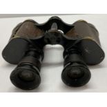 A pair of German WWII style Hensoldt binoculars with engraved Kriegsmarine insignia.