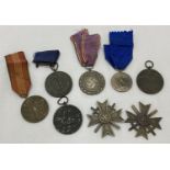 A collection of various German WWII style medals.