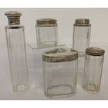 A collection of 5 Victorian & Edwardian silver topped dressing table bottles, all fully hallmarked.
