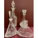 A collection of 4 cut glass and crystal decanters with stoppers.