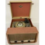 A vintage orange and white Dansette portable record player.