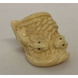 A carved ring, possibly bone, with mouse and ear of corn detail.