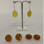 3 pairs of amber earrings; 2 pairs of studs together with a pair of yellow amber drop earrings.