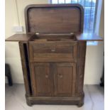 A vintage dark wood top opening bar cabinet.