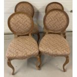 A set of 4 vintage light wood round back dining chairs with paisley style upholstery.