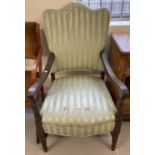 A Victorian dark wood framed armchair with channelled detail to frame and green coloured upholstery.