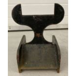 A black painted modern design cast iron boot scraper.