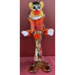 A vintage Murano glass clown figure in red, yellow and brown colourway.