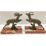 A pair of Art Deco marble based spelter leaping deer mantel figures.