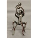 A small silver figural pendant in an erotic pose. Marked 925 to bale.