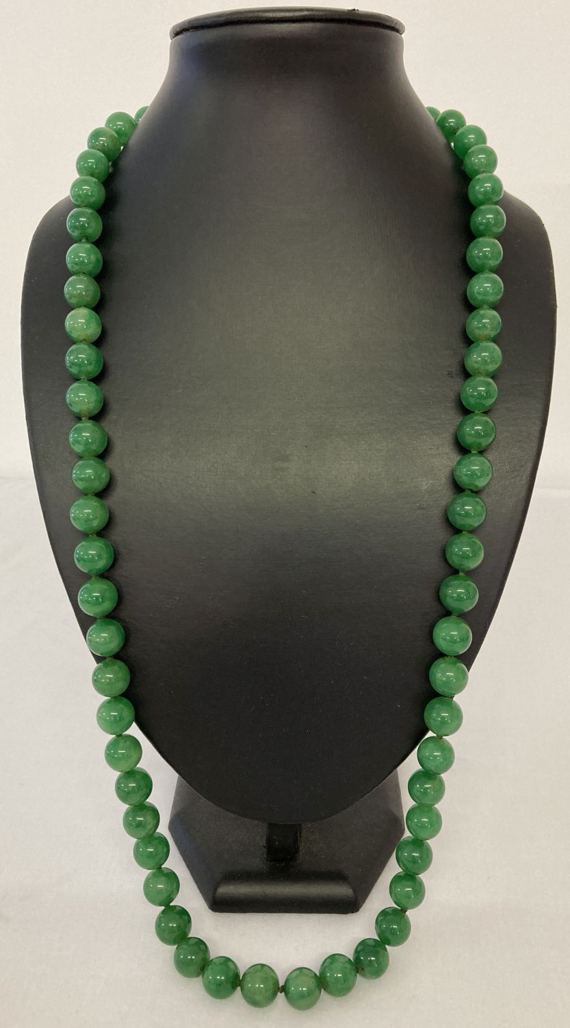 A 31" apple green jade, beaded necklace; knotted between each bead.