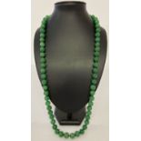A 31" apple green jade, beaded necklace; knotted between each bead.