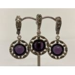 A silver and amethyst pendant and matching earrings set with marcasite's.