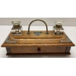 An Edwardian wooden standish complete with original glass ink wells.