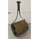A vintage cast iron garden roller with cut-out decoration to both sides.