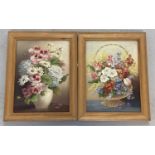 A pair of framed oil on board still life paintings of flowers.