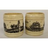 A pair of carved bone scrimshaw style napkin rings, with ship and lighthouse detail.