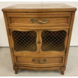 A vintage R Way furniture solid wood 2 door, 2 drawer cabinet with wired panels to door fronts.