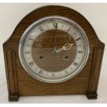 A vintage dark wood cased chiming mantle clock with Enfield movement.