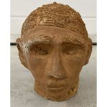 A hand crafted terracotta head sculpture/ornament. Initials T.P to front.