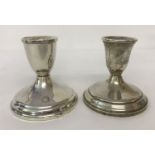 2 sterling silver weighted candlesticks. Circular bases with stepped detail.