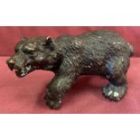 A small bronze figure of a bear.