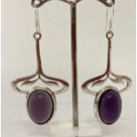 A pair of Art Nouveau style silver and amethyst drop earrings.
