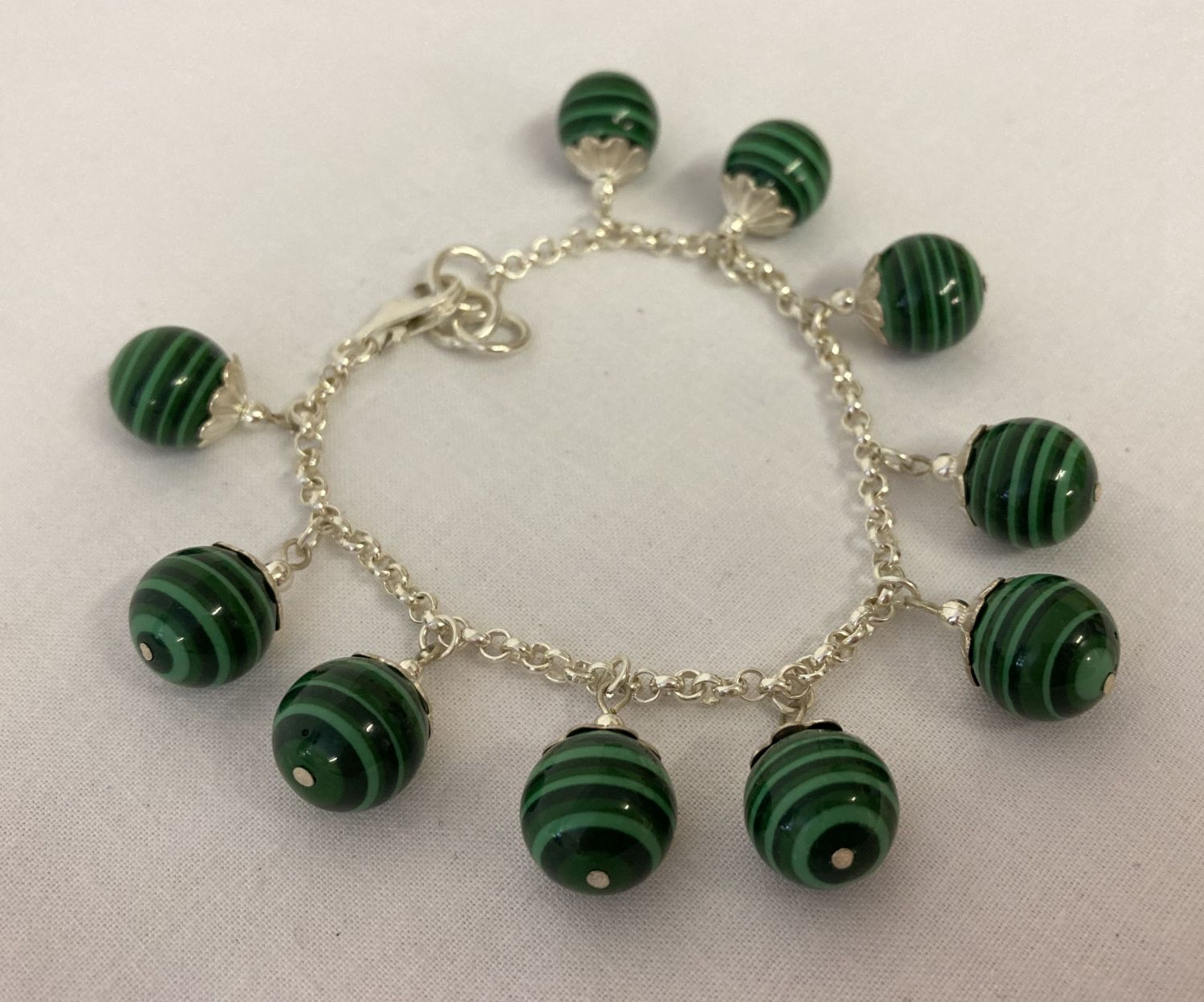 A white metal and malachite bracelet, clasp needs attention.