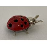 A small sterling silver pin cushion in the form of a ladybird.